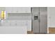 Kitchen area showcases quartz counters, white cabinets, and stainless steel refrigerator at 5526 Southernview Dr, Zephyrhills, FL 33541