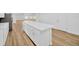 Kitchen island features white cabinets, quartz countertops, and new flooring at 5526 Southernview Dr, Zephyrhills, FL 33541