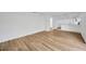 Open concept living space with modern wood-look floors and seamless flow to the kitchen at 5526 Southernview Dr, Zephyrhills, FL 33541