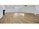 Large living area with new floors, white walls, ample natural light and a fireplace at 5526 Southernview Dr, Zephyrhills, FL 33541