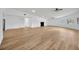 Large, airy living space with wood-look floors, white walls, and an open layout at 5526 Southernview Dr, Zephyrhills, FL 33541