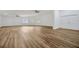 Spacious living room featuring modern flooring, ceiling fans, and abundant natural light at 5526 Southernview Dr, Zephyrhills, FL 33541