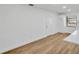 Open living space features wood-look floors and leads into a bright kitchen with white cabinets at 5526 Southernview Dr, Zephyrhills, FL 33541