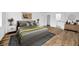 Relaxing bedroom featuring a rug, wood floors, and relaxing neutral decor at 5526 Southernview Dr, Zephyrhills, FL 33541