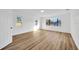 Main bedroom features wood-look flooring, natural light, and neutral paint at 5526 Southernview Dr, Zephyrhills, FL 33541