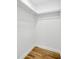 A view of the walk-in closet with shelves and wood-look flooring at 5526 Southernview Dr, Zephyrhills, FL 33541