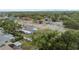 Aerial perspective capturing the property's location amongst neighborhood, with nearby shopping and mature landscaping at 601 Patricia Ave, Dunedin, FL 34698
