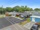 Aerial view of a well-maintained home with ample parking, a blue shed, and a cozy front yard at 601 Patricia Ave, Dunedin, FL 34698