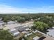 Captivating aerial view highlighting the home's backyard retreat and neighborhood with lush tree coverage at 601 Patricia Ave, Dunedin, FL 34698