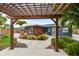 Backyard featuring a pergola, lush tropical landscaping, stone pavers, and access to a yard with playset at 601 Patricia Ave, Dunedin, FL 34698