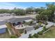 Backyard oasis featuring a fire pit area, patio with mini palms, playset, shed, and fenced for privacy at 601 Patricia Ave, Dunedin, FL 34698
