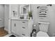 Clean bathroom with white vanity, a lighted mirror, and neutral accents at 601 Patricia Ave, Dunedin, FL 34698