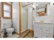 Bathroom with toilet, vanity, and glass shower at 601 Patricia Ave, Dunedin, FL 34698