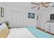 Neat bedroom featuring a ceiling fan, double closets, and patriotic decor at 601 Patricia Ave, Dunedin, FL 34698