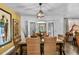 Dining room with wicker chairs, modern light fixture, and adjacent french doors at 601 Patricia Ave, Dunedin, FL 34698