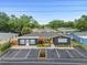 Charming single-story home with a gray exterior, a bright yellow door, and plenty of parking at 601 Patricia Ave, Dunedin, FL 34698