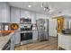 Well-lit kitchen boasts stainless steel appliances, granite countertops, and updated lighting at 601 Patricia Ave, Dunedin, FL 34698