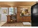 Compact kitchen with wooden ceiling and cabinets, designed for convenience and efficiency at 601 Patricia Ave, Dunedin, FL 34698