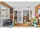 Bright office space with sliding doors to backyard, built-in shelving, and a view to the kitchen at 601 Patricia Ave, Dunedin, FL 34698