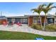 Inviting backyard with a paved patio, fire pit, and lush lawn, perfect for outdoor entertaining and relaxation at 601 Patricia Ave, Dunedin, FL 34698