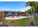 Spacious backyard featuring a patio, fire pit, and well-manicured lawn, ideal for outdoor activities and enjoyment at 601 Patricia Ave, Dunedin, FL 34698