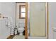 Bathroom includes toilet, towel rack, shower and frosted window with wooden trim at 601 Patricia Ave, Dunedin, FL 34698