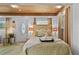 Cozy bedroom featuring wood ceiling, plush bedding, and decorative lighting offering a peaceful retreat at 601 Patricia Ave, Dunedin, FL 34698