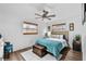 Serene bedroom with a comfortable bed, ceiling fan, and natural light from two windows at 601 Patricia Ave, Dunedin, FL 34698