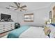 Inviting bedroom featuring a cozy bed with soft blue bedding and natural light, creating a peaceful retreat at 601 Patricia Ave, Dunedin, FL 34698