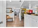Inviting entryway leads to a stylish kitchen and living area, featuring wood-look floors and modern design at 601 Patricia Ave, Dunedin, FL 34698