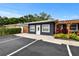 Charming navy blue home with ample parking, a cozy pergola and tasteful landscaping at 601 Patricia Ave, Dunedin, FL 34698
