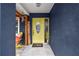 Welcoming front entrance features a vibrant yellow door, decorative accents, and a cozy, inviting ambiance at 601 Patricia Ave, Dunedin, FL 34698