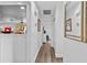 Bright hallway with wood-look floors and modern decor leading to other areas of the house at 601 Patricia Ave, Dunedin, FL 34698