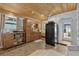 Kitchen features wood-paneled ceiling, modern appliances, and a breakfast nook with bench seating at 601 Patricia Ave, Dunedin, FL 34698