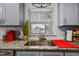 Close-up of a kitchen sink with granite countertops, stylish fixtures, and a bright window at 601 Patricia Ave, Dunedin, FL 34698