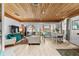 Open-concept living area with stylish furniture, dining area, and view of the connected bedroom at 601 Patricia Ave, Dunedin, FL 34698