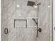 Luxurious shower with marble tiling, rainfall showerhead, and a convenient built-in niche for toiletries at 601 Patricia Ave, Dunedin, FL 34698