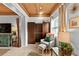 Cozy sitting area featuring a comfortable chair, dark wood storage, and decorative window with natural light at 601 Patricia Ave, Dunedin, FL 34698