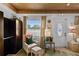 Charming sitting area with chair, ottoman, dark wood wardrobe, and a decorative window with natural light at 601 Patricia Ave, Dunedin, FL 34698