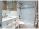 Stylishly updated bathroom featuring granite vanity and shower over tub with white subway tile at 6015 19Th N St # 311, St Petersburg, FL 33714