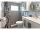 Updated bathroom with tiled walk-in shower, granite vanity, new fixtures, and decorative mirror at 6015 19Th N St # 311, St Petersburg, FL 33714