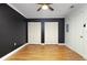 Bedroom featuring wood-look floors, ceiling fan, and closet at 6015 19Th N St # 311, St Petersburg, FL 33714