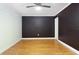 Bedroom featuring wood-look floors, ceiling fan, and dark color scheme at 6015 19Th N St # 311, St Petersburg, FL 33714