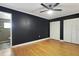 Spacious bedroom featuring hardwood floors, ceiling fan, dark accent wall and multiple closets at 6015 19Th N St # 311, St Petersburg, FL 33714