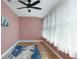 Unfurnished bedroom featuring light wood flooring, natural light, and a fan at 6015 19Th N St # 311, St Petersburg, FL 33714