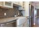Charming kitchen featuring custom cabinets, stainless steel appliances, and a farmhouse sink at 6015 19Th N St # 311, St Petersburg, FL 33714