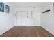 Empty living room featuring hardwood floors, neutral paint and trim and two closets at 6015 19Th N St # 311, St Petersburg, FL 33714
