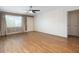 Spacious living room with hardwood floors, neutral paint, ceiling fan and a large window at 6015 19Th N St # 311, St Petersburg, FL 33714