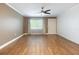 Spacious living room features hardwood floors, neutral paint, ceiling fan and a large window at 6015 19Th N St # 311, St Petersburg, FL 33714