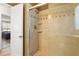 Bright bathroom featuring a glass shower with tile surround and built-in shelves at 707 24Th Sw St, Largo, FL 33770